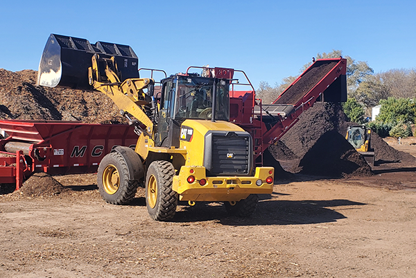 tractor moving wood mulch